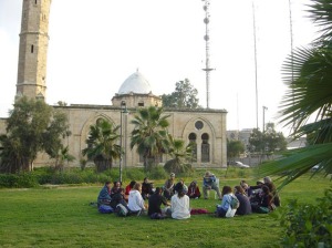 Israseli Settlers sitting in the courtyard of the Grand Mosque after being turned into musem